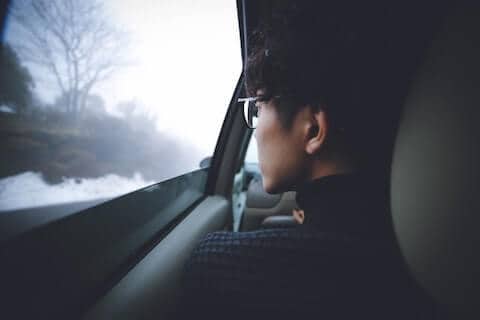 Person looking out the window depicting pridefulness